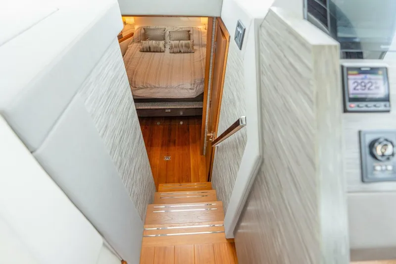 Slide: The Image of Stairway leading to a cozy bedroom in a 2021 Tiara Yachts F44 Flybridge. - 27