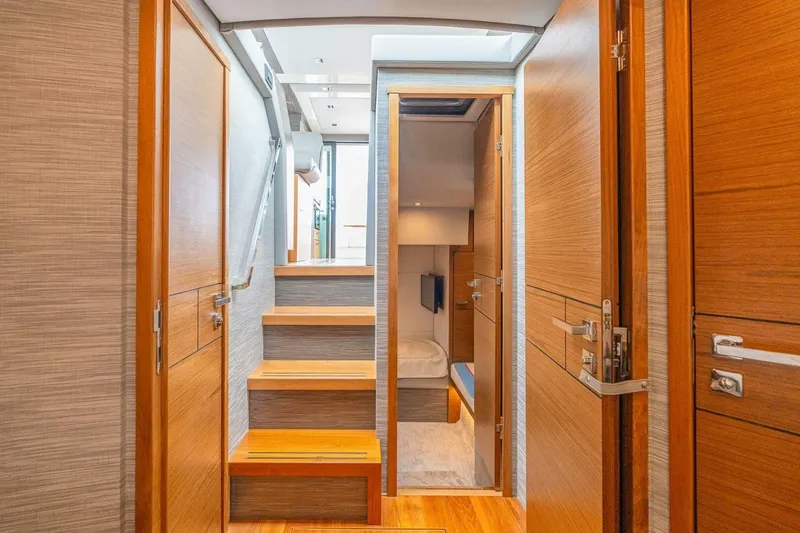 Slide: The Image of Interior of 2021 Tiara Yachts F44 Flybridge, featuring wooden doors and stairs. - 30