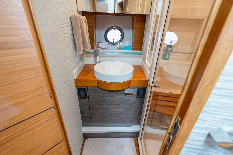 Slide: The Image of Luxurious bathroom in 2021 Tiara Yachts F44 Flybridge with modern sink and wooden accents. - 32