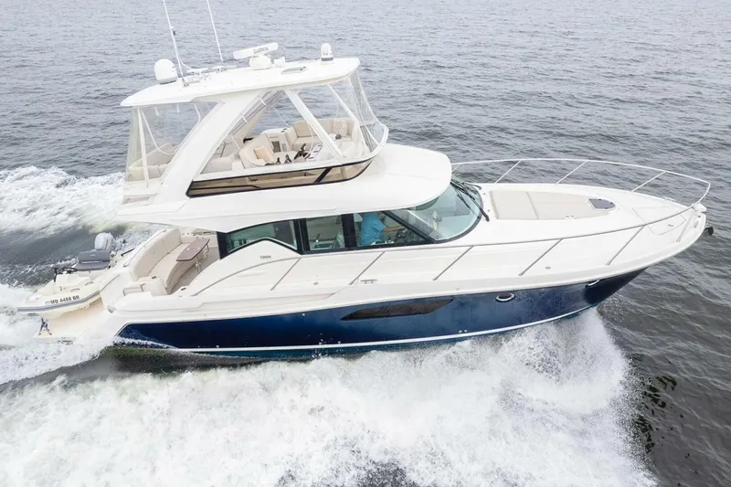 Slide: The Image of 2021 Tiara Yachts F44 Flybridge cruising on open water, showcasing sleek design and luxury. - 4