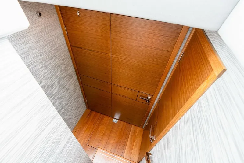 Slide: The Image of 2021 Tiara Yachts F44 Flybridge interior with wooden door and flooring. - 41