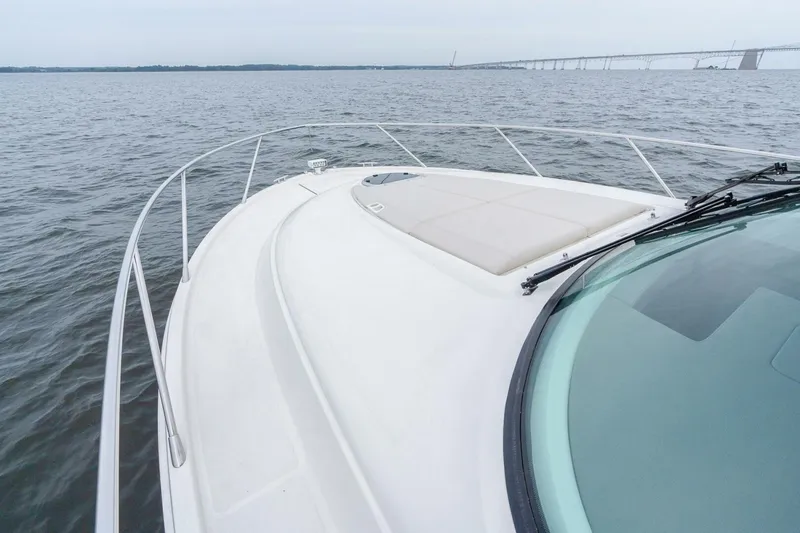 Slide: The Image of 2021 Tiara Yachts F44 Flybridge on open water with bridge in background. - 44