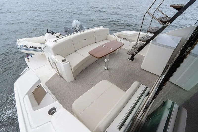 Slide: The Image of 2021 Tiara Yachts F44 Flybridge with spacious deck and seating area on the water. - 47