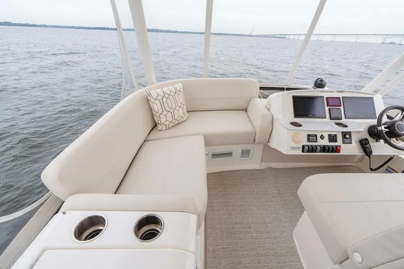 Slide: The Image of Flybridge of 2021 Tiara Yachts F44, featuring plush seating and modern navigation controls. - 49