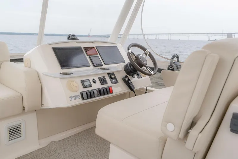 Slide: The Image of 2021 Tiara Yachts F44 Flybridge helm with modern controls and steering wheel. - 56