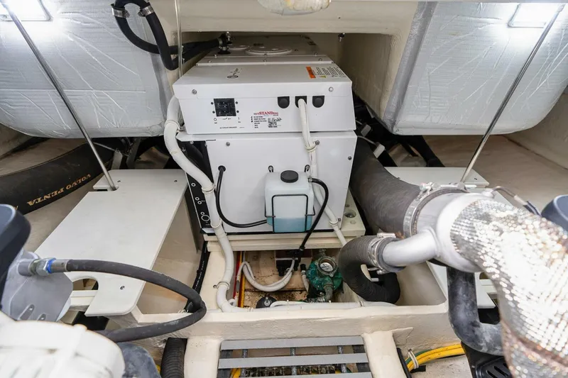 Slide: The Image of Engine room of 2021 Tiara Yachts F44 Flybridge with generator and wiring. - 58
