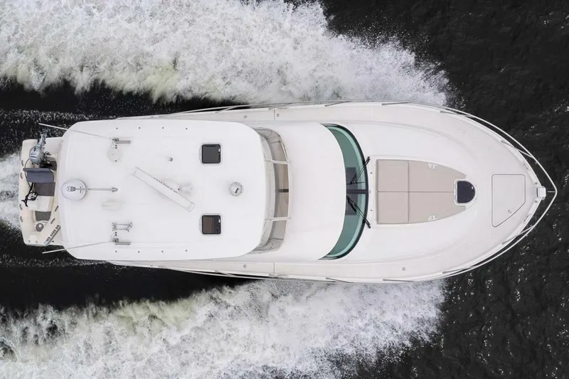 Slide: The Image of Overhead view of 2021 Tiara Yachts F44 Flybridge cruising on water. - 9