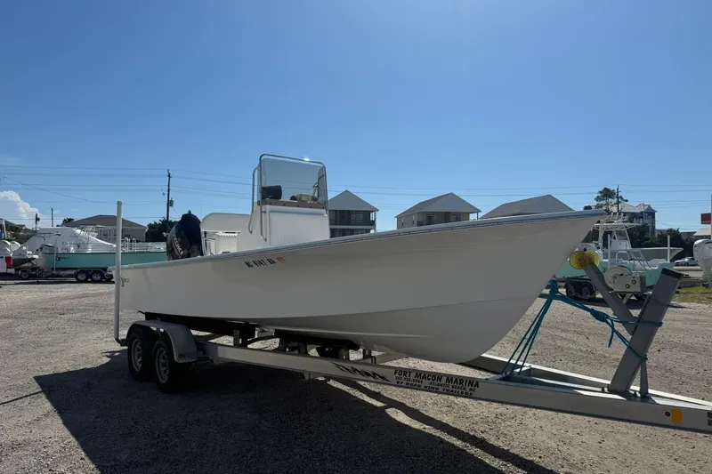 Slide: The Image of 2018 C-Hawk 23 Center Console boat on trailer in marina setting. - 1