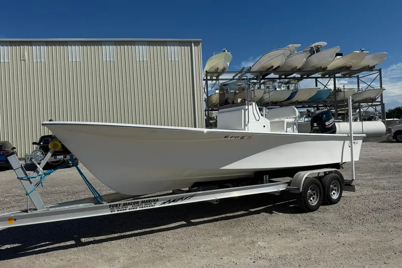 Slide: The Image of 2018 C-Hawk 23 Center Console boat on trailer, parked outdoors under clear sky. - 11
