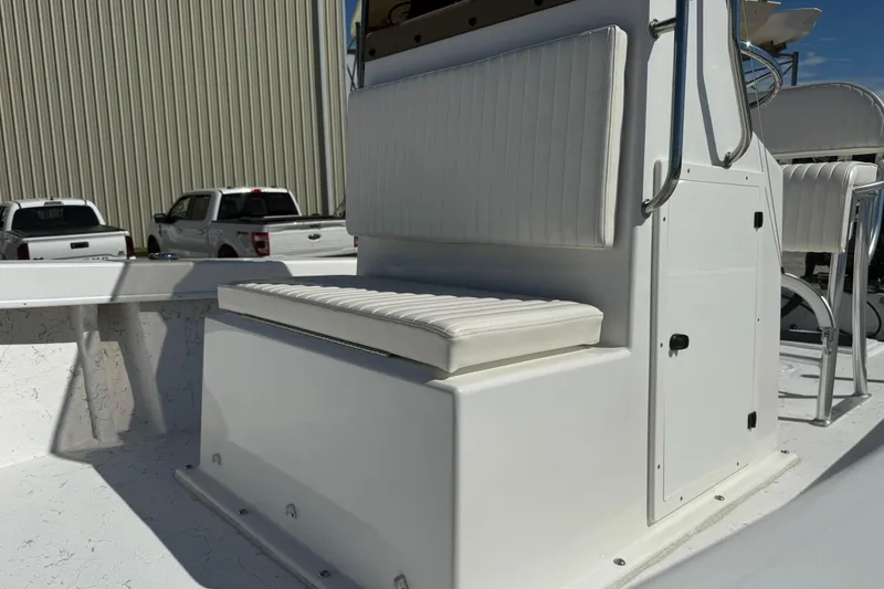 Slide: The Image of 2018 C-Hawk 23 Center Console boat interior with white seating and storage. - 12