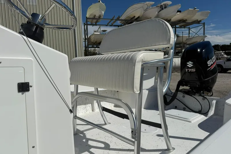 Slide: The Image of 2018 C-Hawk 23 Center Console boat with Suzuki 175 outboard motor, docked outdoors. - 13