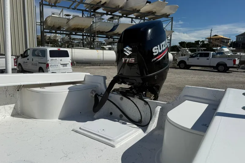 Slide: The Image of 2018 C-Hawk 23 Center Console with Suzuki 175 outboard motor in a boatyard. - 14
