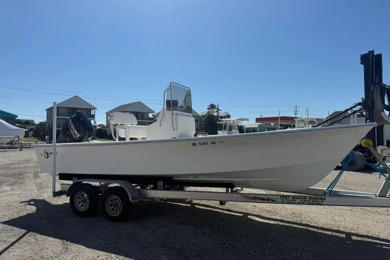 Slide: The Image of 2018 C-Hawk 23 Center Console boat on trailer at marina. - 2