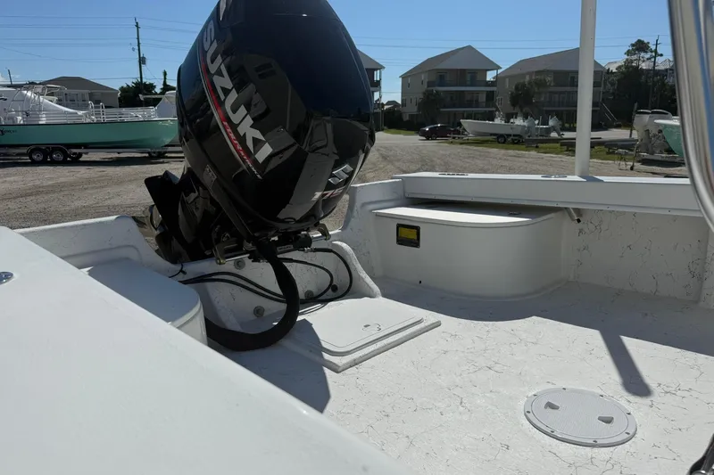 Slide: The Image of 2018 C-Hawk 23 Center Console boat with Suzuki outboard motor, docked in a marina. - 7