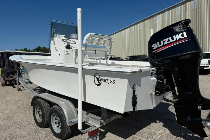 Slide: The Image of 2018 C-Hawk 23 Center Console boat with Suzuki outboard motor on a trailer. - 9