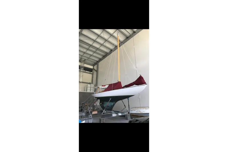 Slide: The Image of Wooden deck of 2017 Classic Dark Harbor 17 1/2 sailboat with package and sunglasses. - 22