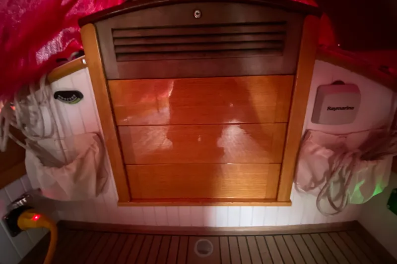 Slide: The Image of Interior of 2017 Classic Dark Harbor 17 1/2 sailboat with wooden cabinetry and nautical equipment. - 32