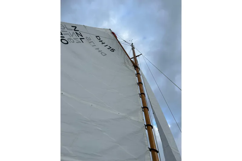 Slide: The Image of Sail of a 2017 Classic Dark Harbor 17 1/2 against a cloudy sky. - 33