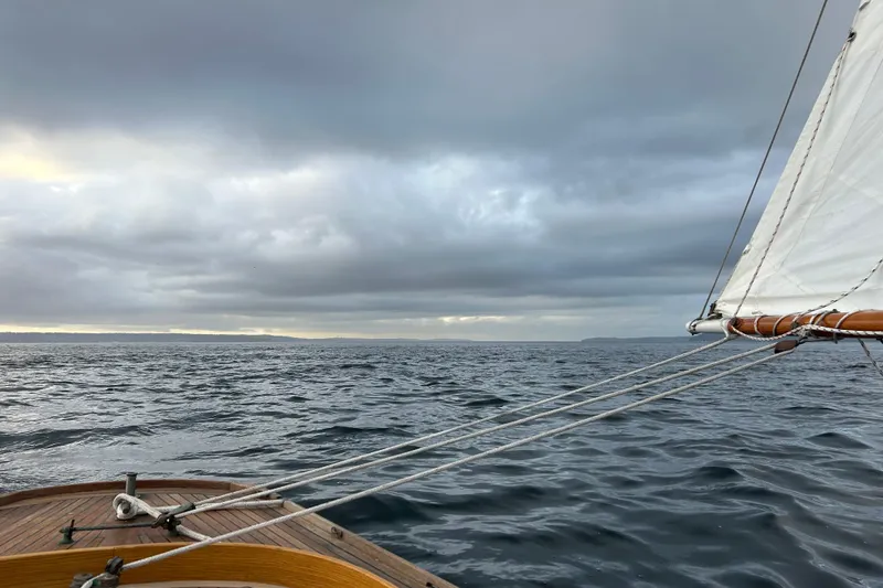 Slide: The Image of Sailing on a Classic Dark Harbor 17 1/2, 2017 model, under cloudy skies. - 34