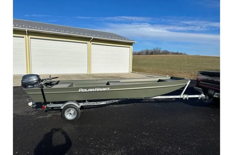 Slide: The Image of 2024 Polar Kraft 1648 Jon Boat with Yamaha 20 hp engine on trailer, parked outdoors. - 3