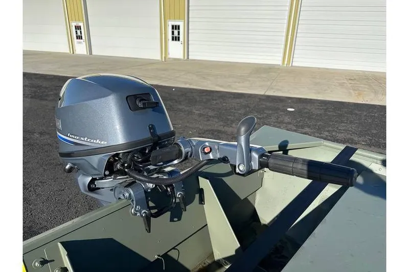 Slide: The Image of 2024 Polar Kraft 1648 Jon Boat with Yamaha 20 hp motor, parked outside. - 5