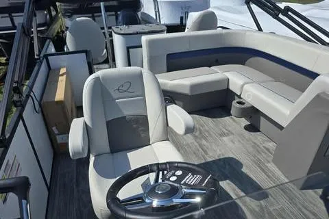 Slide: The Image of 2026 Qwest XRE E-Class boat interior with modern seating and steering wheel. - 5