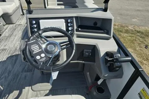 Slide: The Image of 2026 Qwest XRE E-Class boat dashboard with steering wheel and control panel. - 6