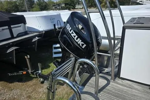 Slide: The Image of Outboard motor on 2026 Qwest XRE E-Class boat, featuring Suzuki branding. - 9