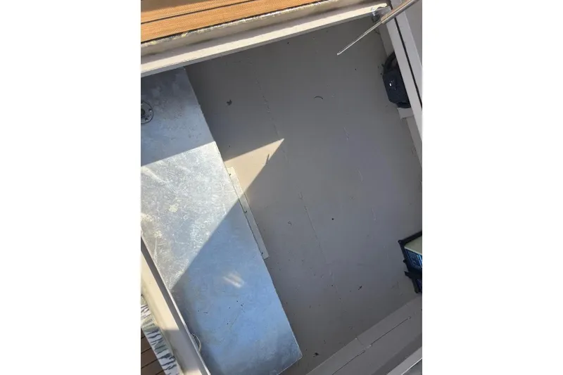 Slide: The Image of Battery compartment of 2024 Cobb's Custom Boats 1854, featuring secure wiring and connections. - 10