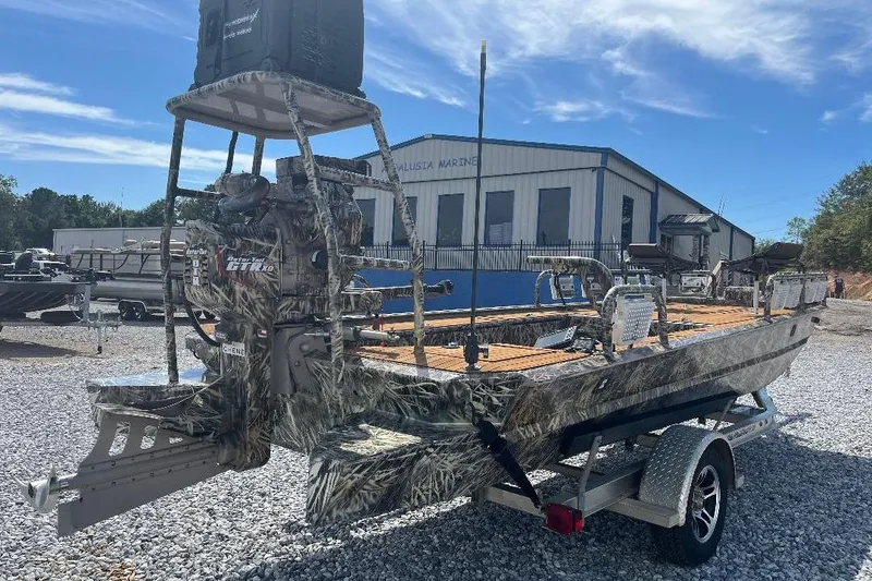 Slide: The Image of Custom 2024 model 1854 boat with Yamaha outboard motor, parked on gravel. - 3