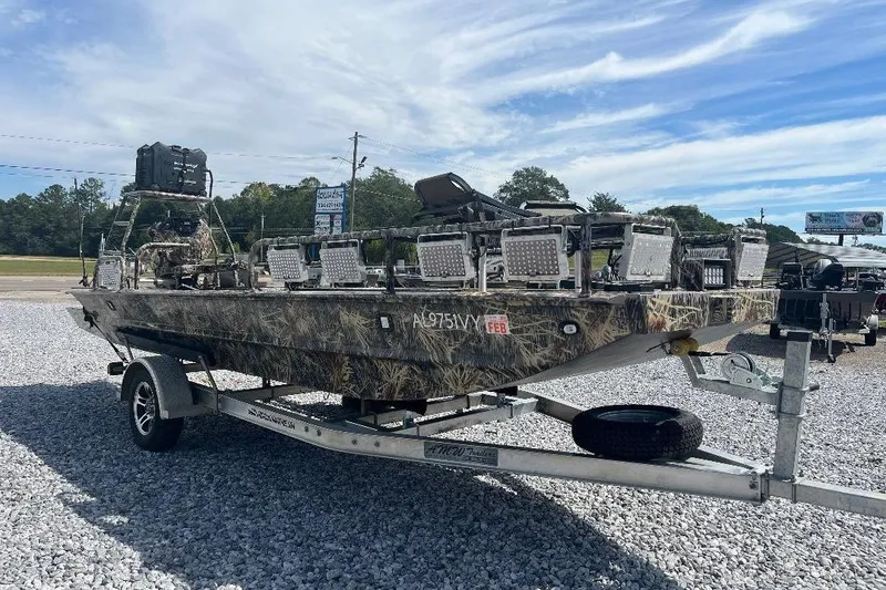 Slide: The Image of 2024 Cobb's Custom Boats 1854 dashboard with Garmin display and Auxbeam controls. - 5