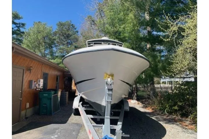 Slide: The Image of 2000 Hydra-Sports 2796 CC Vector boat on trailer, surrounded by trees and a building. - 1