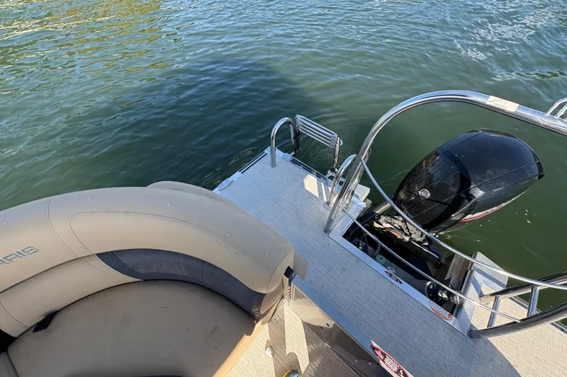 Slide: The Image of 2023 Harris HCX 230 Stern Radius boat with motor and seating, on water. - 10