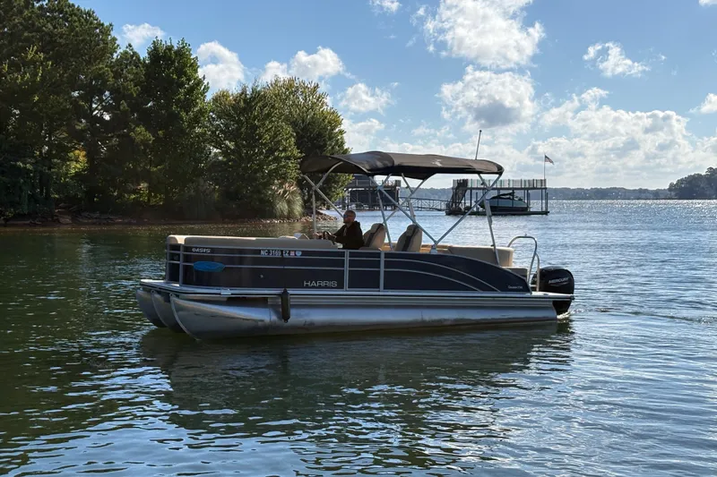Slide: The Image of 2023 Harris HCX 230 Stern Radius pontoon boat on a sunny lake. - 18