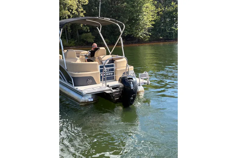 Slide: The Image of 2023 Harris HCX 230 Stern Radius pontoon boat interior with beige seating and canopy. - 4