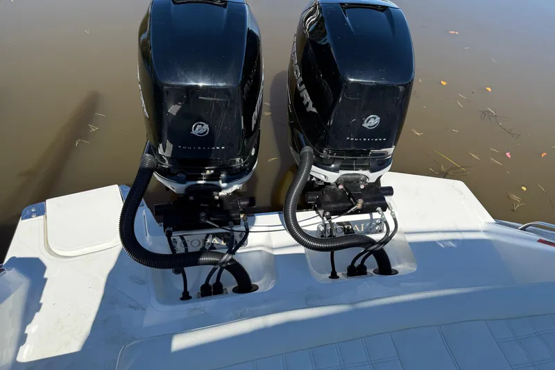 Slide: The Image of Twin Mercury outboard engines on a 2021 Cobalt 30SC boat, docked on calm water. - 11
