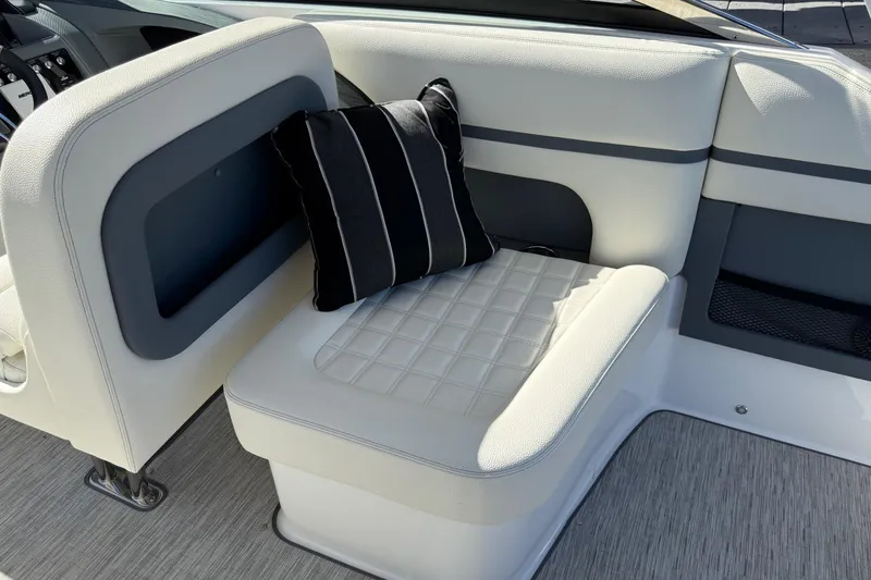 Slide: The Image of 2021 Cobalt 30SC boat interior with cushioned seating and striped pillow. - 13