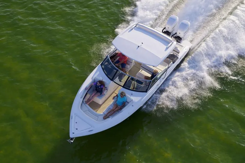 Slide: The Image of Manufacturer Provided Image: 2021 Cobalt 30SC boat cruising on green water with passengers relaxing. - 15