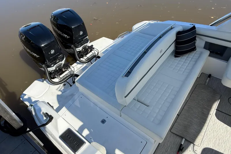 Slide: The Image of 2021 Cobalt 30SC boat with dual Mercury outboard engines and white seating. - 3