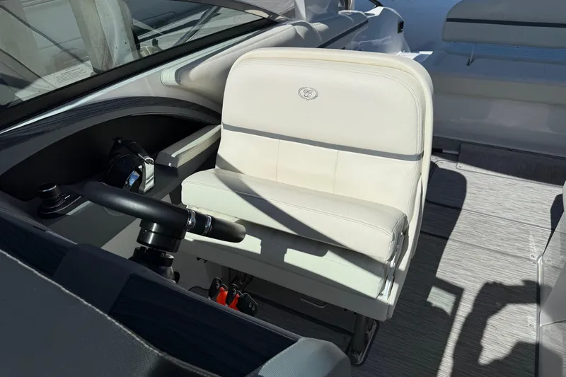 Slide: The Image of 2021 Cobalt 30SC boat interior with white captain's chair and steering wheel. - 5