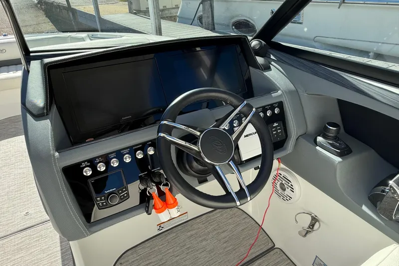 Slide: The Image of 2021 Cobalt 30SC boat dashboard with steering wheel and control panel. - 6