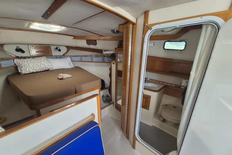 Slide: The Image of Interior of 1999 Nauset 33 Bridge Deck boat with cozy cabin and bathroom. - 10