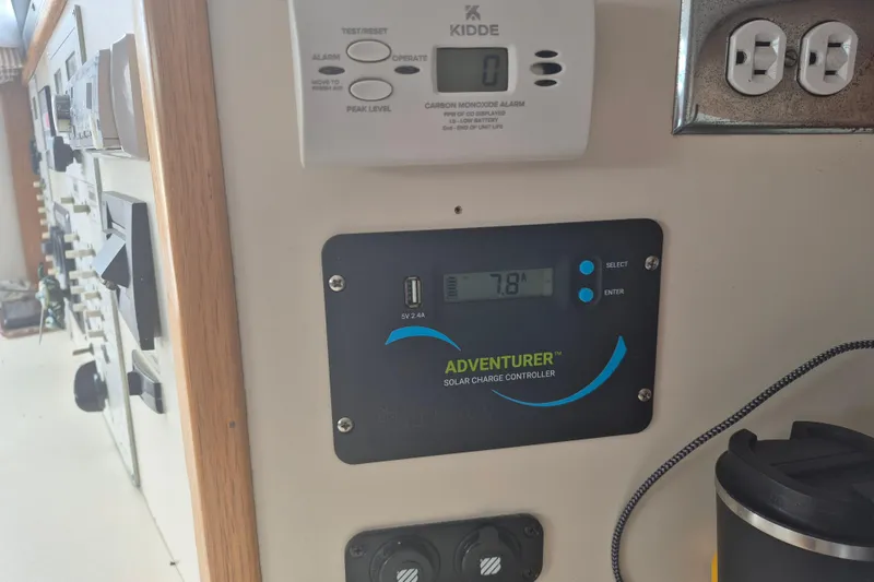 Slide: The Image of Control panel on 1999 Nauset 33 Bridge Deck with solar charge controller and carbon monoxide alarm. - 16