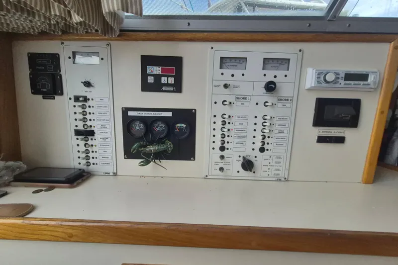 Slide: The Image of Control panel of a 1999 Nauset 33 Bridge Deck boat with gauges and switches. - 17