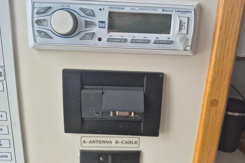 Slide: The Image of 1999 Nauset 33 Bridge Deck stereo system and antenna switch panel. - 18