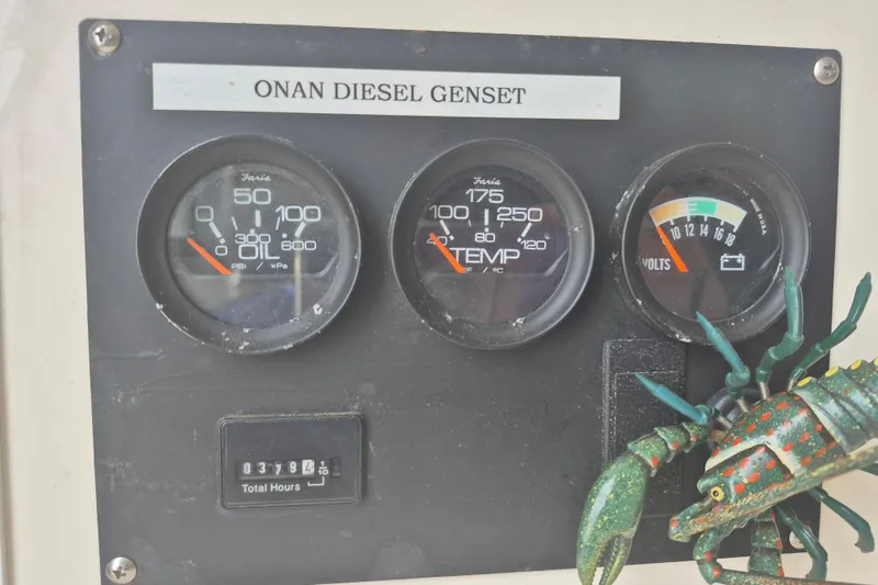 Slide: The Image of Control panel of a 1999 Nauset 33 Bridge Deck with Onan diesel generator gauges. - 19