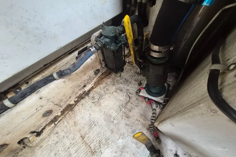 Slide: The Image of Engine compartment of a 1999 Nauset 33 Bridge Deck boat, showing hoses and fittings. - 26