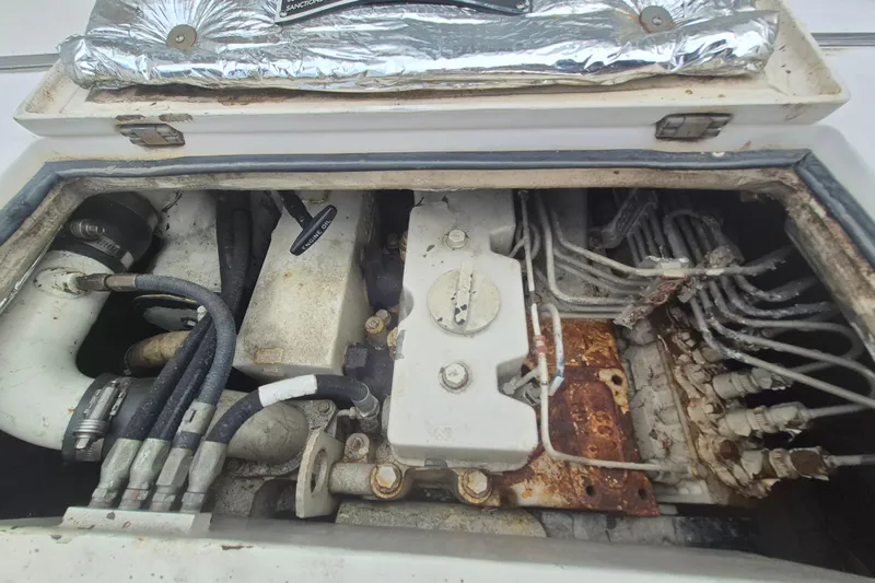 Slide: The Image of Engine compartment of a 1999 Nauset 33 Bridge Deck boat, showing hoses and components. - 27