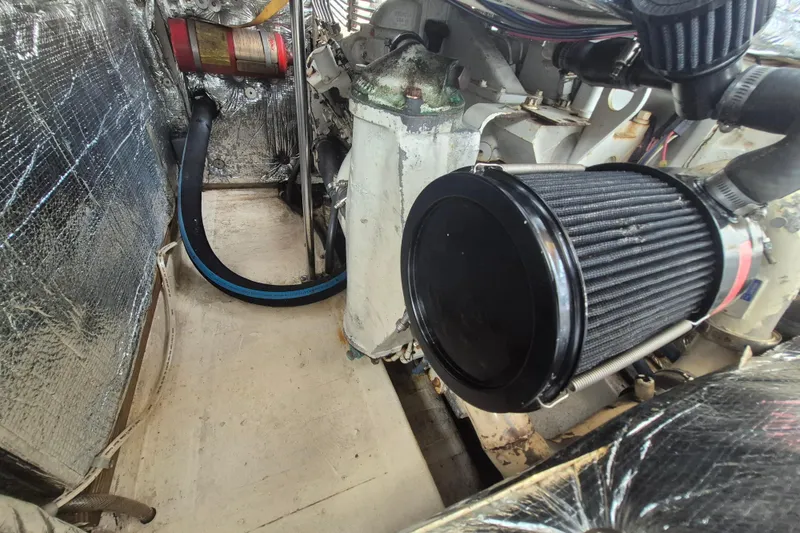 Slide: The Image of Engine compartment of a 1999 Nauset 33 Bridge Deck boat with visible air filter. - 28