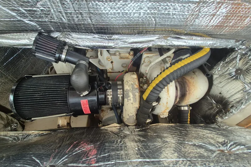 Slide: The Image of Engine compartment of a 1999 Nauset 33 Bridge Deck boat with visible components. - 29